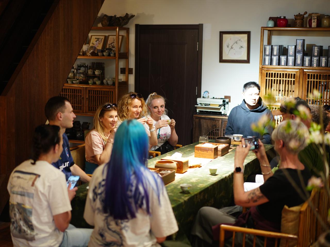 Travelers tasting tea and enjoying tea ceremony