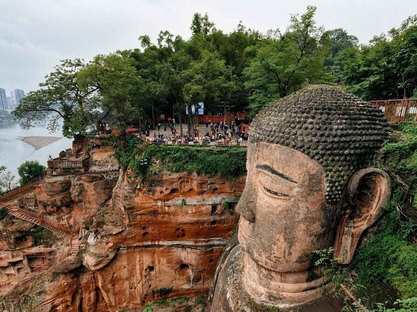 Guided tour of Leshan Giant Buddha. Visit Lingyun Temple for Buddhist heritage insights. Descend Nine-Turn Plank Path for close-up views of the 71-meter Tang-Dynasty Giant Buddha. Learn its construction stories and engineering facts. Take photos at Lingyun Mountain viewpoint overlooking the Buddha and three-river confluence. - Photo 2