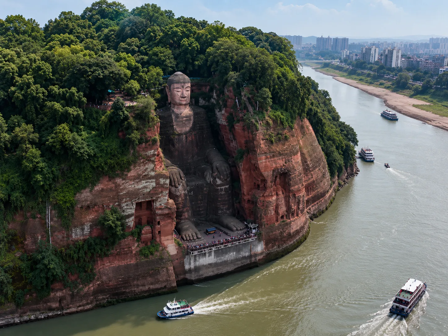 Guided tour of Leshan Giant Buddha. Visit Lingyun Temple for Buddhist heritage insights. Descend Nine-Turn Plank Path for close-up views of the 71-meter Tang-Dynasty Giant Buddha. Learn its construction stories and engineering facts. Take photos at Lingyun Mountain viewpoint overlooking the Buddha and three-river confluence. - Photo 1